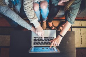 People point towards a laptop screen